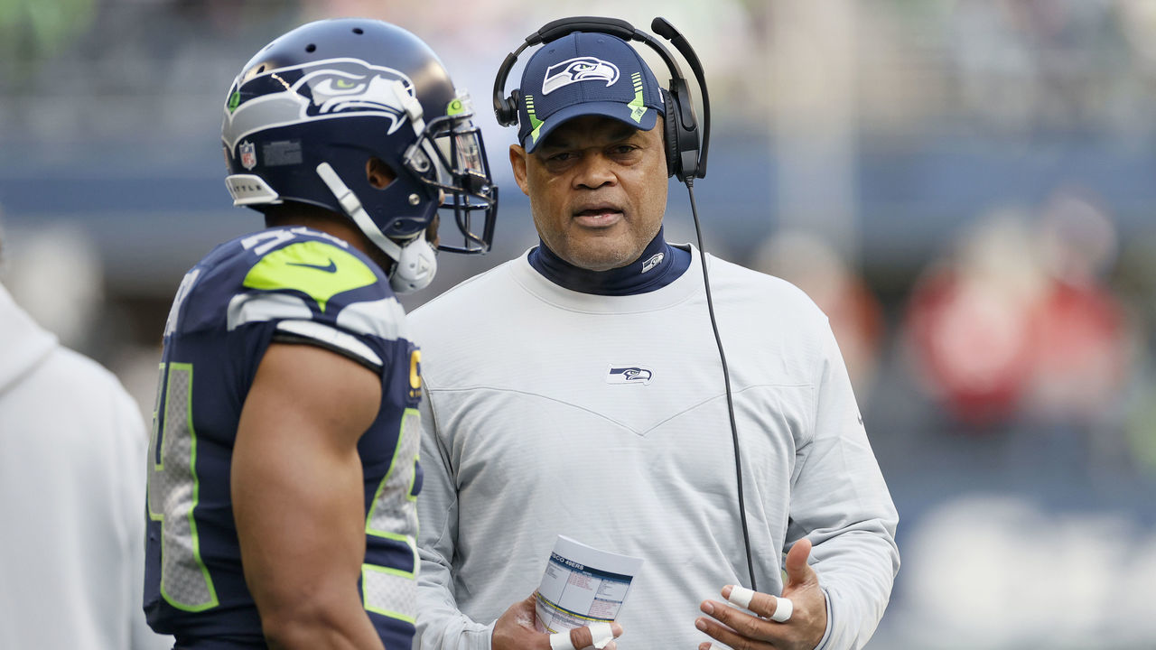 SEATTLE, WASHINGTON - DECEMBER 05: Bobby Wagner #54 and defensive coordinator Ken Norton Jr. of the Seattle Seahawks talk during the first quarter against the San Francisco 49ers at Lumen Field on December 05, 2021 in Seattle, Washington.