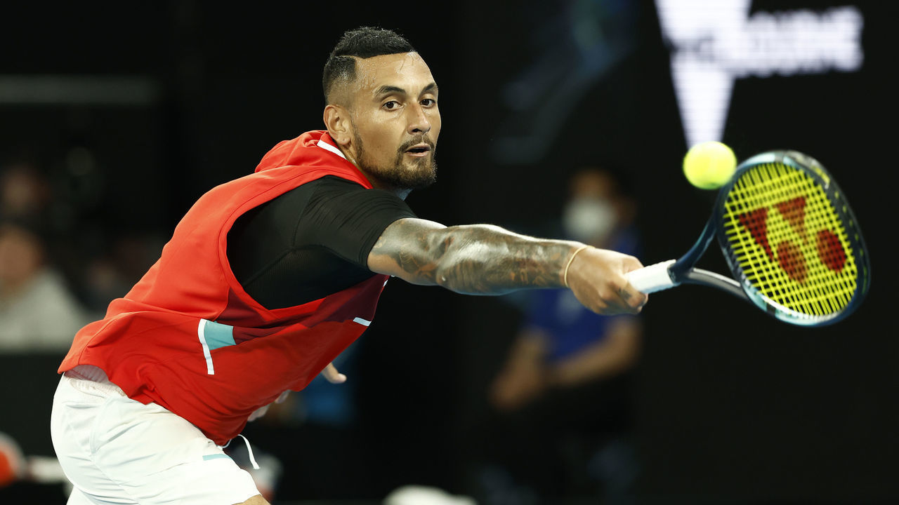 MELBOURNE, AUSTRALIA - JANUARY 18: Nick Kyrgios of Australia plays a backhand in his first round singles match against Liam Broady of Great Britain during day two of the 2022 Australian Open at Melbourne Park on January 18, 2022 in Melbourne, Australia.