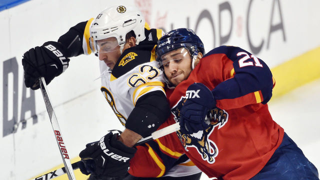 SUNRISE, FL - OCTOBER 30: Brad Marchand #63 of the Boston Bruins crosses sticks with Vincent Trocheck #21 of the Florida Panthers during a NHL game at the BB&T Center on October 30, 2015 in Sunrise, Florida.