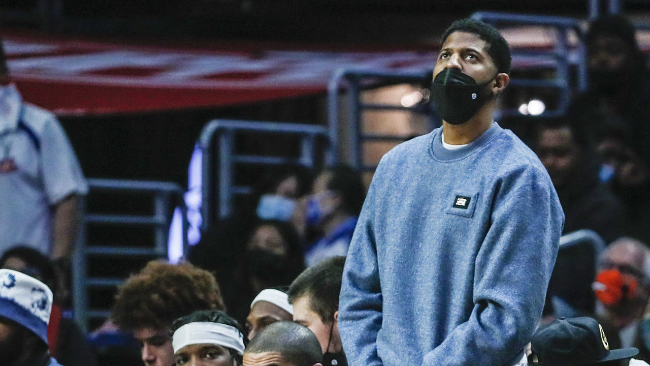Los Angeles, CA, Sunday, December 26, 2021 -Paul George, standing and Kawhi Leonard, right, watch the action against the Denver Nuggets from the bench at Crypto.com Arena. (Robert Gauthier/Los Angeles Times via Getty Images)
