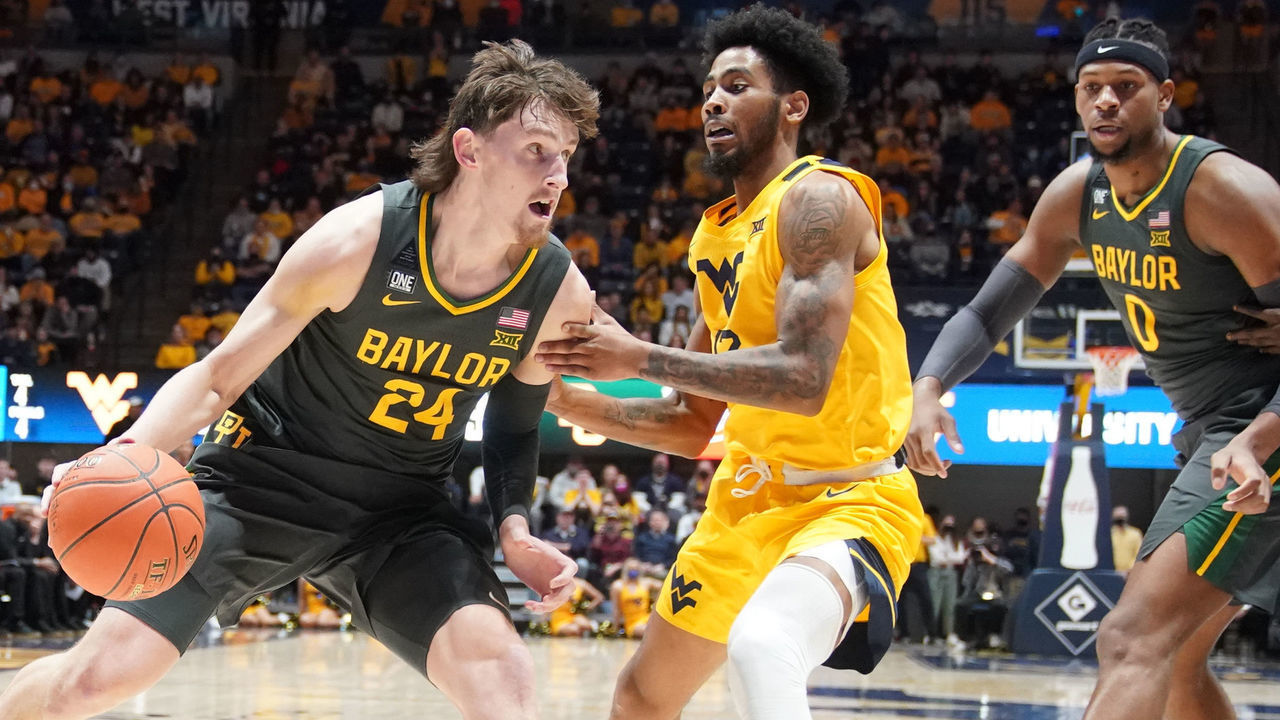 MORGANTOWN, WEST VIRGINIA - JANUARY 18: Matthew Mayer #24 of the Baylor Bears dribbles by Taz Sherman #12 of the West Virginia Mountaineers in the first half during a college basketball game at the WVU Coliseum on January 18, 2022 in Morgantown, West Virginia.