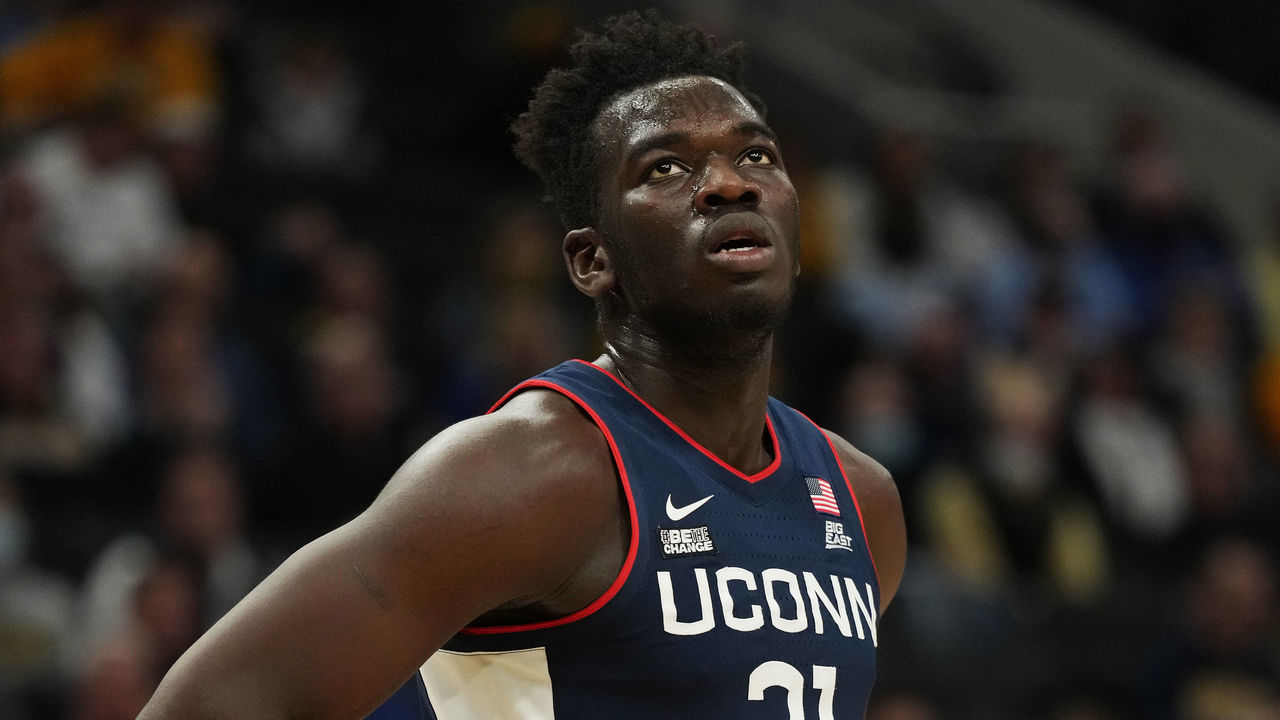 MILWAUKEE, WISCONSIN - DECEMBER 21: Adama Sanogo #21 of the Connecticut Huskies looks on against the Marquette Golden Eagles in the first half at Fiserv Forum on December 21, 2021 in Milwaukee, Wisconsin.