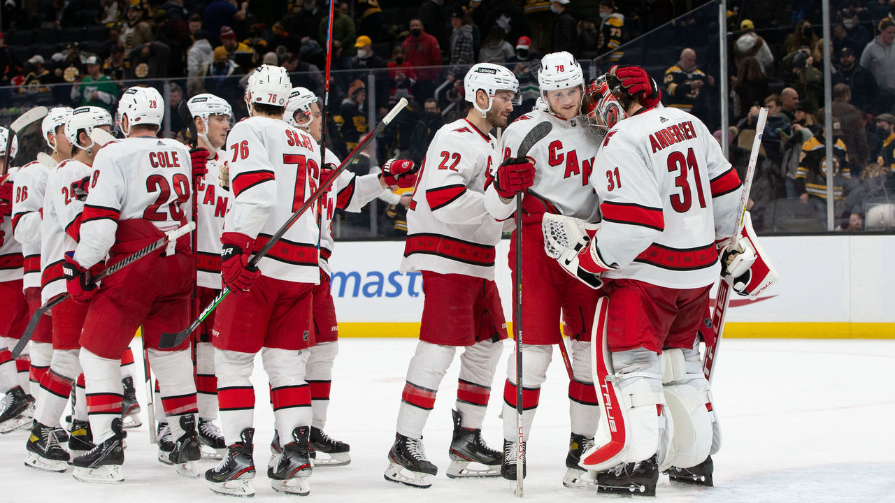 BOSTON, MA - JANUARY 18: Frederik Andersen #31 of the Carolina Hurricanes celebrates a 7-1 victory against the Boston Bruins with teammates Steven Lorentz #78 and Brett Pesce #22 at the TD Garden on January 18, 2022 in Boston, Massachusetts.