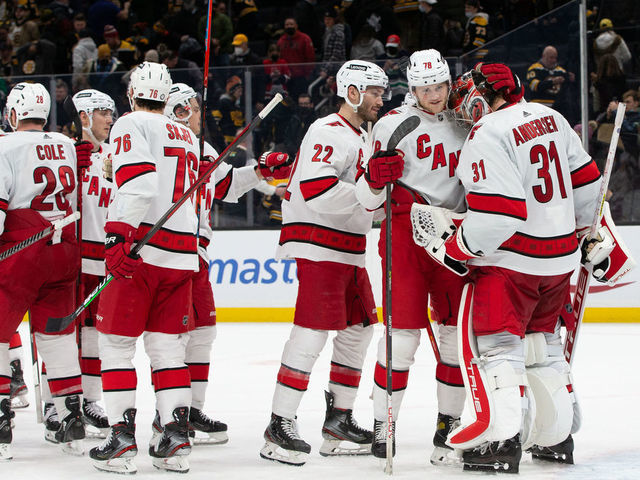 BOSTON, MA - JANUARY 18: Frederik Andersen #31 of the Carolina Hurricanes celebrates a 7-1 victory against the Boston Bruins with teammates Steven Lorentz #78 and Brett Pesce #22 at the TD Garden on January 18, 2022 in Boston, Massachusetts.