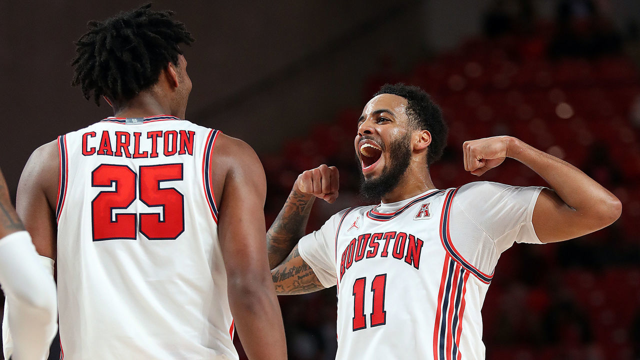 HOUSTON, TEXAS - JANUARY 18: Kyler Edwards #11 of the Houston Cougars celebrates with Josh Carlton #25 during the second half against the South Florida Bulls at Fertitta Center on January 18, 2022 in Houston, Texas.
