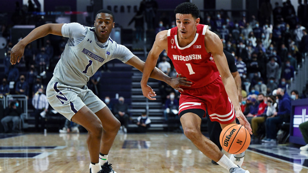 EVANSTON, ILLINOIS - JANUARY 18: Johnny Davis #1 of the Wisconsin Badgers drives against Chase Audige #1 of the Northwestern Wildcats in the first half at Welsh-Ryan Arena on January 18, 2022 in Evanston, Illinois.