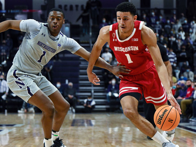 EVANSTON, ILLINOIS - JANUARY 18: Johnny Davis #1 of the Wisconsin Badgers drives against Chase Audige #1 of the Northwestern Wildcats in the first half at Welsh-Ryan Arena on January 18, 2022 in Evanston, Illinois.