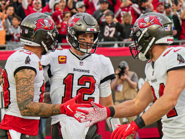 Tampa Bay Buccaneers quarterback Tom Brady (12) celebrates with wide  receiver Mike Evans (13) a …