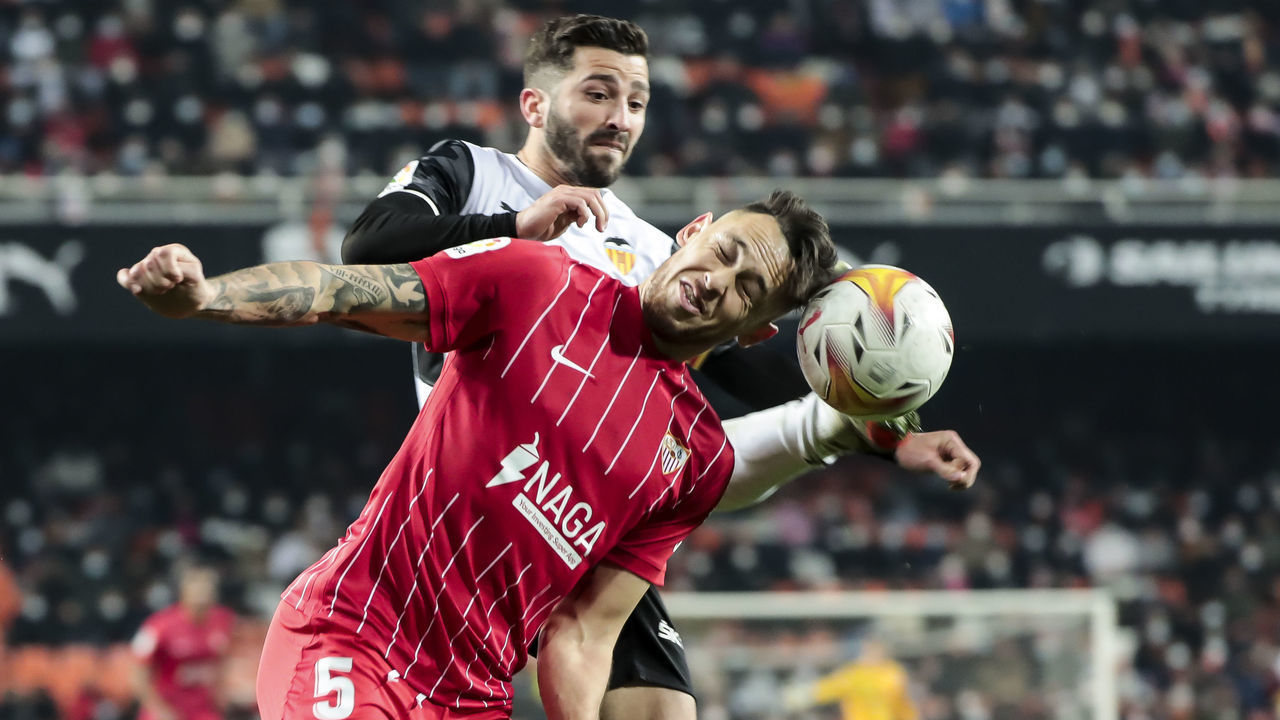 Lucas Adrian Ocampos of Sevilla FC (L) and Jose Luis Gaya of Valencia CF during La Liga match between Valencia CF and Sevilla CF at Mestalla Stadium on January 19, 2022.