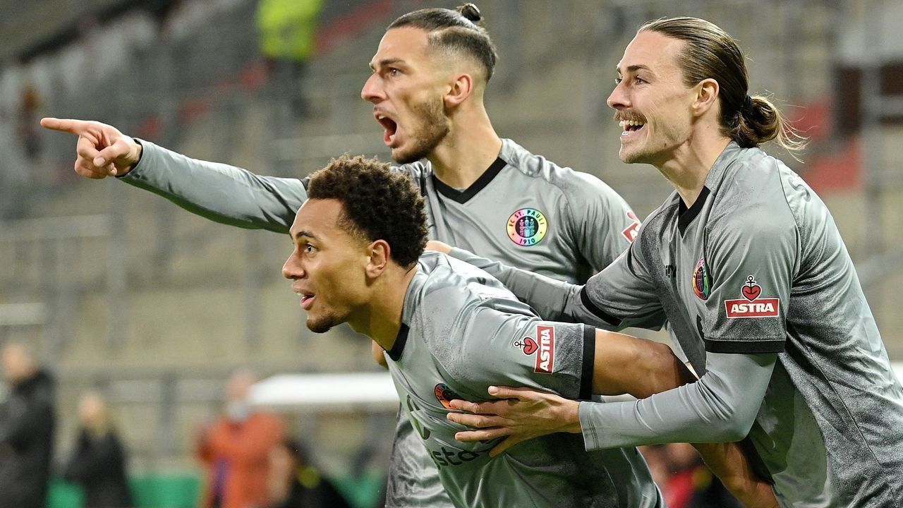 Etienne Amenyido 1st L of St. Pauli celebrates scoring during the German Cup round of 16 football match between FC St. Pauli and Borussia Dortmund in Hamburg, Germany, Jan. 18, 2022.