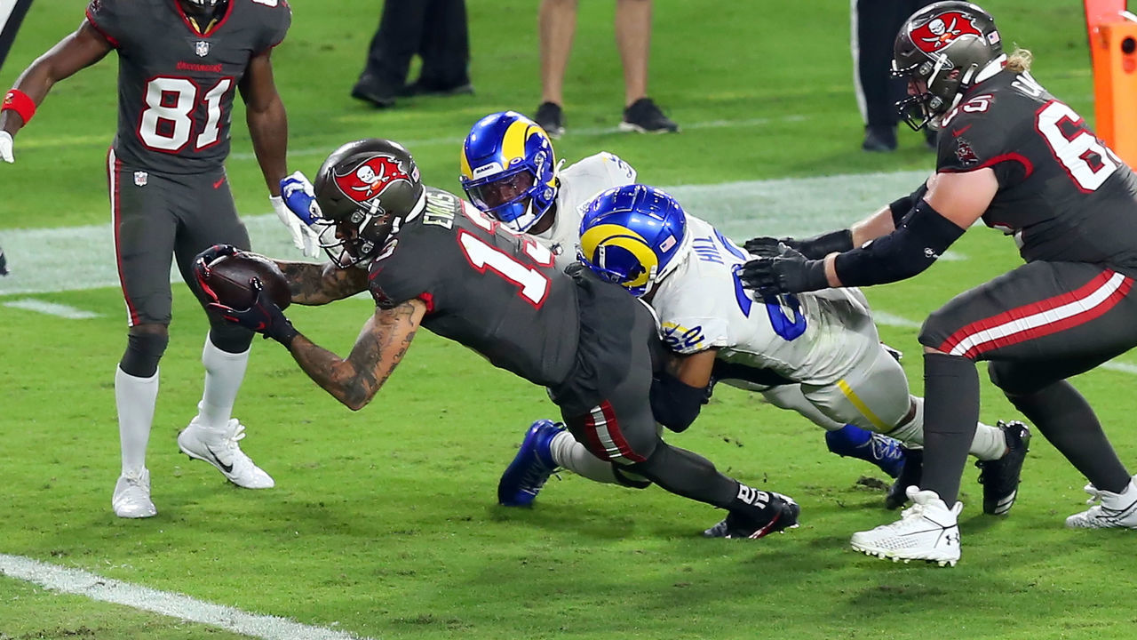 TAMPA, FL - NOVEMBER 23: Mike Evans (13) of the Bucs fought off two Rams defenders to dive into the end zone for the touchdown during the regular season game between the Los Angeles Rams and the Tampa Bay Buccaneers on November 23, 2020 at Raymond James Stadium in Tampa, Florida.