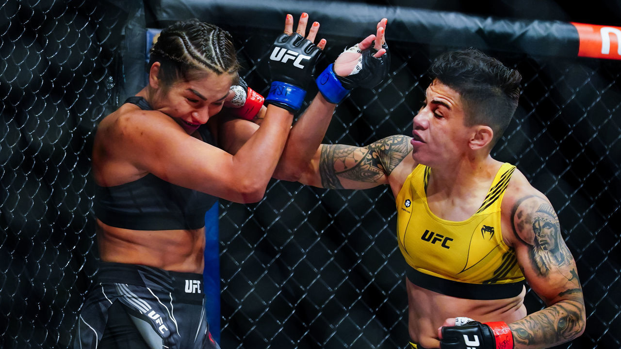 LAS VEGAS, NV - SEPTEMBER 25: Jéssica Andrade punches Cynthia Cavillo during the first round of their Flyweight fight during UFC 266 at T-Mobile Arena on September 25, 2021 in Las Vegas, Nevada.