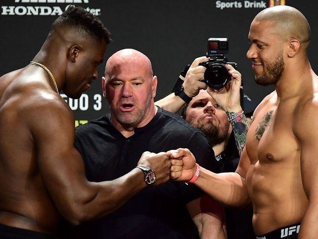 UFC 270 heavyweight world champion Cameroon's Francis Ngannou (L) and France's Ciryl Gane (R) bump fists as they weigh-in at the Anaheim Convention Center in Anaheim, California on January 21, 2022.