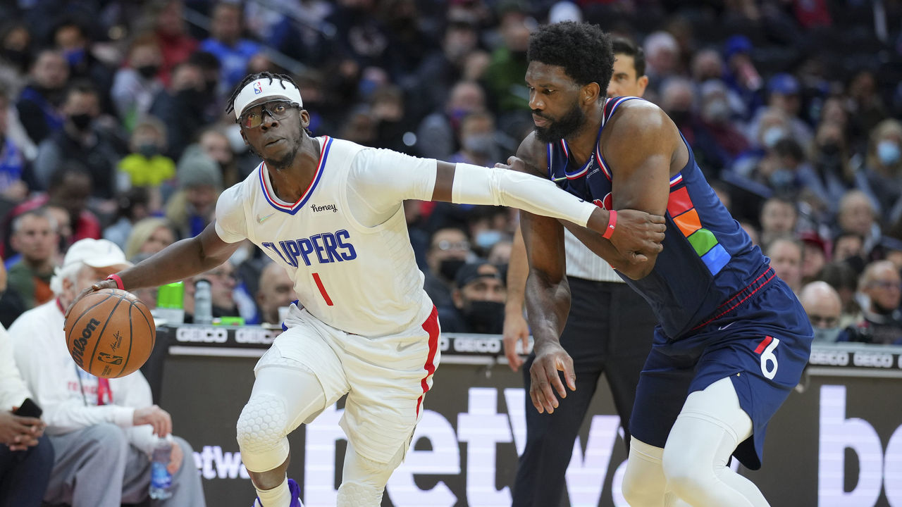 PHILADELPHIA, PA - JANUARY 21: Reggie Jackson #1 of the LA Clippers drives to the basket against Joel Embiid #21 of the Philadelphia 76ers in the first half at the Wells Fargo Center on January 21, 2022 in Philadelphia, Pennsylvania.