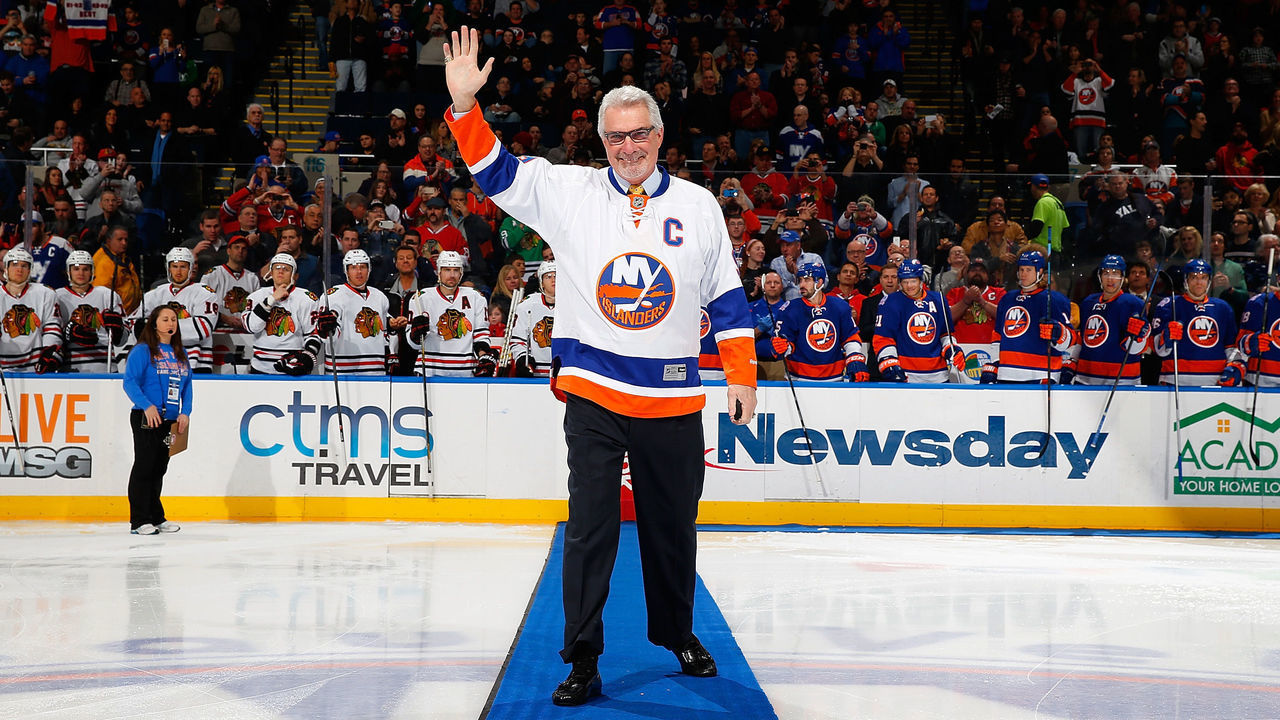 UNIONDALE, NY - DECEMBER 13: NHL Hall of Famer Clark Gillies waves to the crowd prior to a game against the Chicago Blackhawks at Nassau Veterans Memorial Coliseum on December 13, 2014 in Uniondale, New York. The New York Islanders defeated the Chicago Blackhawks 3-2.