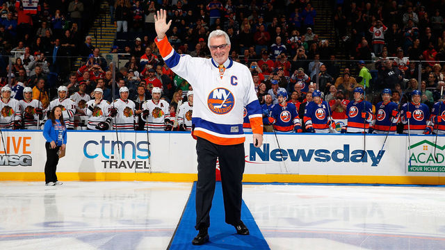 UNIONDALE, NY - DECEMBER 13: NHL Hall of Famer Clark Gillies waves to the crowd prior to a game against the Chicago Blackhawks at Nassau Veterans Memorial Coliseum on December 13, 2014 in Uniondale, New York. The New York Islanders defeated the Chicago Blackhawks 3-2.