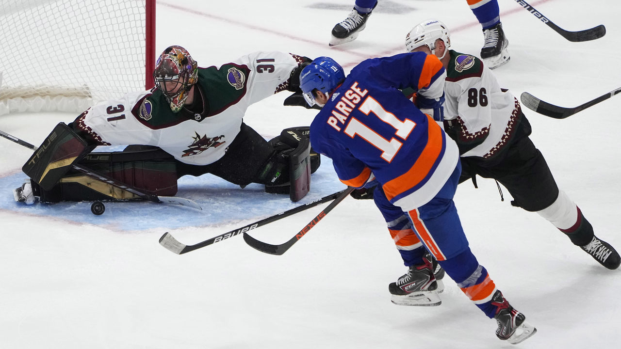 ELMONT, NY - JANUARY 21: New York Islanders Left Wing Zach Parise (11) takes a shot on goal with Arizona Coyotes Goalie Scott Wedgewood (31) making the save during the third period of the National Hockey League game between the Arizona Coyotes and the New York Islanders on January 21, 2022, at UBS Arena in Elmont, NY.