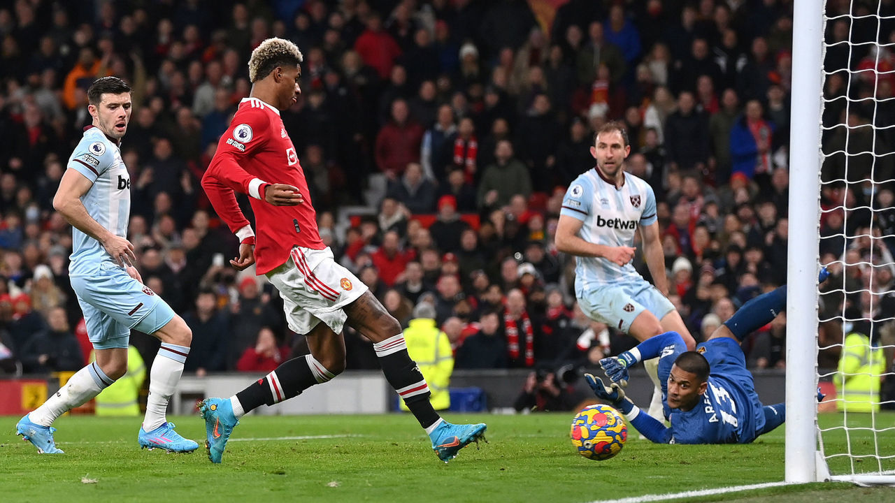 MANCHESTER, ENGLAND - JANUARY 22: Marcus Rashford of Manchester United scores their team's first goal during the Premier League match between Manchester United and West Ham United at Old Trafford on January 22, 2022 in Manchester, England.