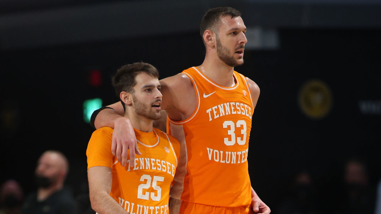 NASHVILLE, TN - JANUARY 18: Tennessee Volunteers guard Santiago Vescovi (25) and Tennessee Volunteers forward Uros Plavsic (33) walk back to the bench for a timeout during a game between the Vanderbilt Commodores and Tennessee Volunteers, January 18, 2022 at Memorial Gymnasium in Nashville, Tennessee.