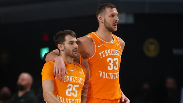 NASHVILLE, TN - JANUARY 18: Tennessee Volunteers guard Santiago Vescovi (25) and Tennessee Volunteers forward Uros Plavsic (33) walk back to the bench for a timeout during a game between the Vanderbilt Commodores and Tennessee Volunteers, January 18, 2022 at Memorial Gymnasium in Nashville, Tennessee.