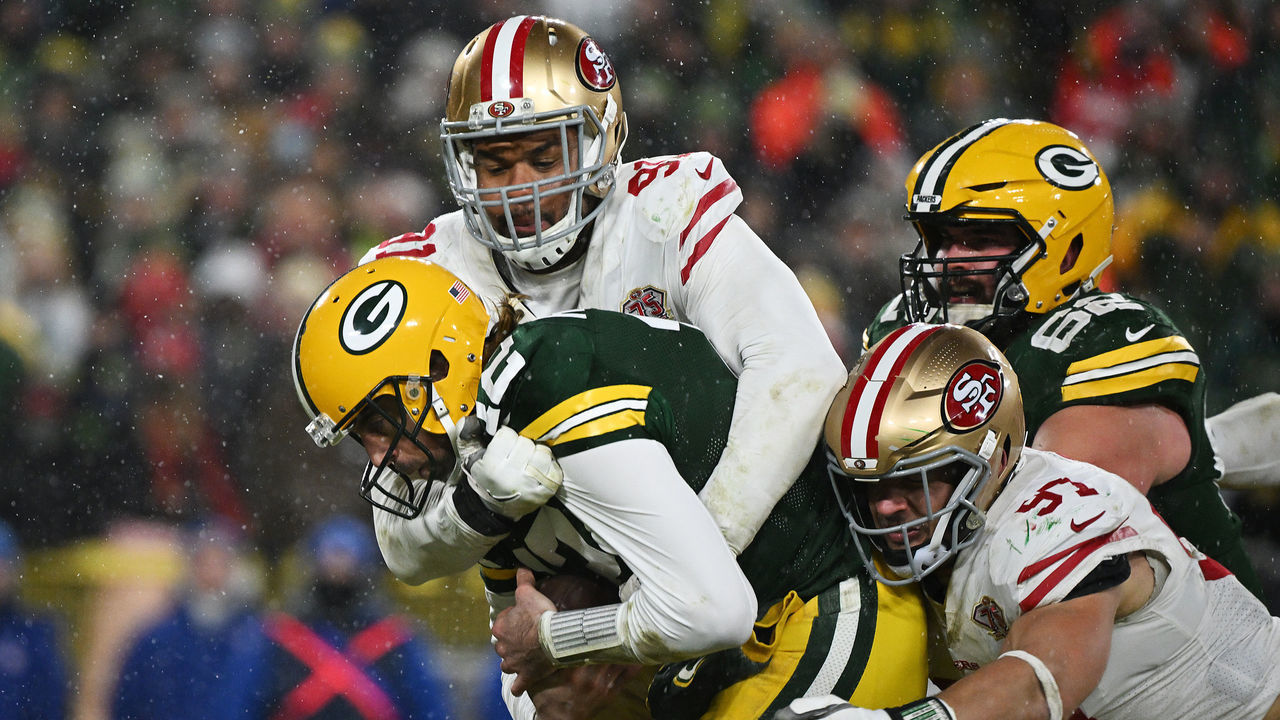 GREEN BAY, WISCONSIN - JANUARY 22: Quarterback Aaron Rodgers #12 of the Green Bay Packers is sacked during the 3rd quarter of the NFC Divisional Playoff game against the San Francisco 49ers at Lambeau Field on January 22, 2022 in Green Bay, Wisconsin.