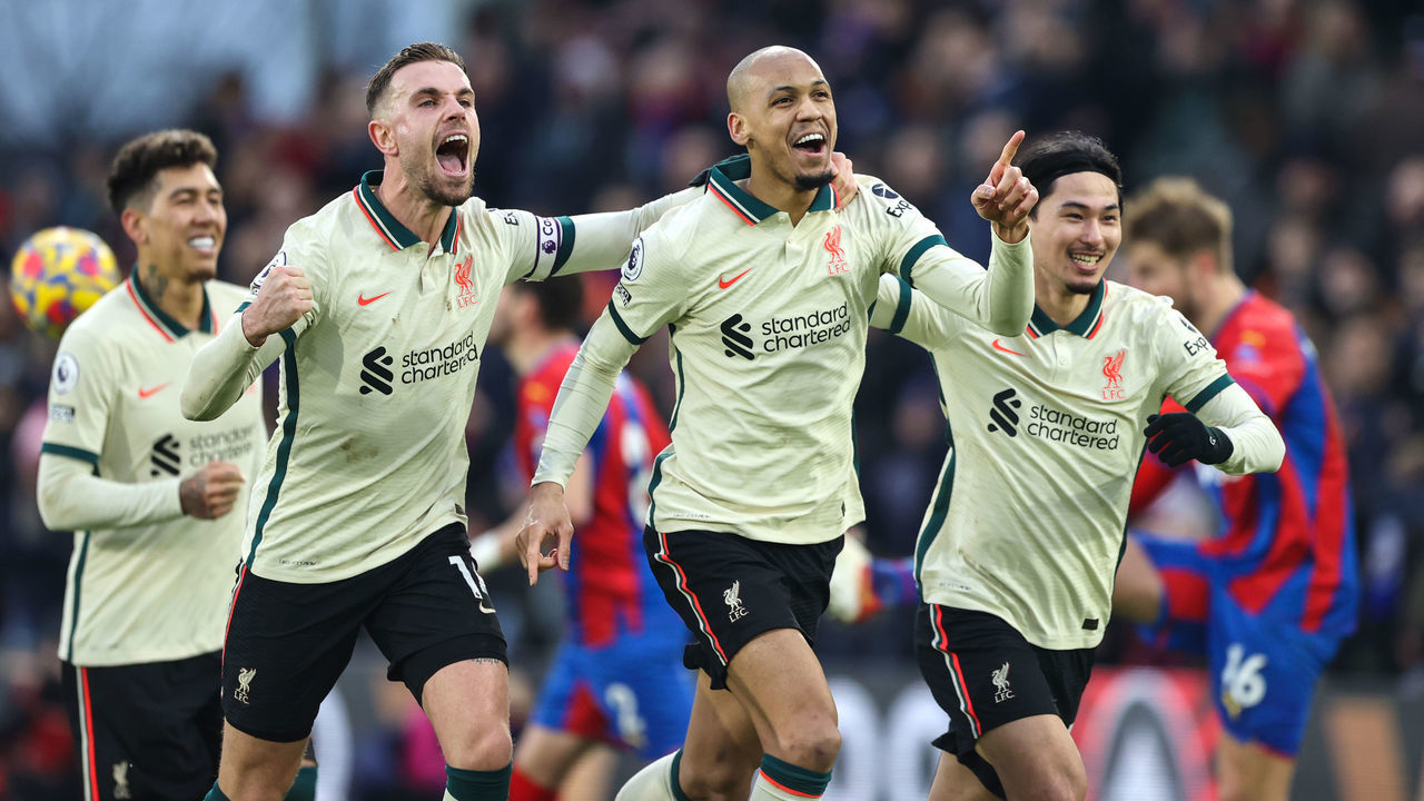 LONDON, ENGLAND - JANUARY 23: Fabinho of Liverpool celebrates scoring their 3rd goal from the penalty spot with Jordan Henderson and Takumi Minamino during the Premier League match between Crystal Palace and Liverpool at Selhurst Park on January 23, 2022 in London, United Kingdom.