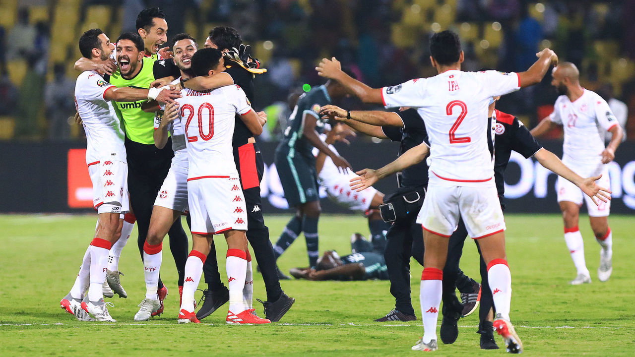 Tunisia's players celebrate after winning the Africa Cup of Nations (CAN) 2021 round of 16 football match between Nigeria and Tunisia at Stade Roumde Adjia in Garoua on January 23, 2022.