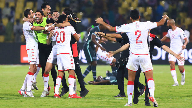 Tunisia's players celebrate after winning the Africa Cup of Nations (CAN) 2021 round of 16 football match between Nigeria and Tunisia at Stade Roumde Adjia in Garoua on January 23, 2022.