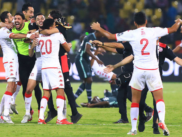 Tunisia's players celebrate after winning the Africa Cup of Nations (CAN) 2021 round of 16 football match between Nigeria and Tunisia at Stade Roumde Adjia in Garoua on January 23, 2022.