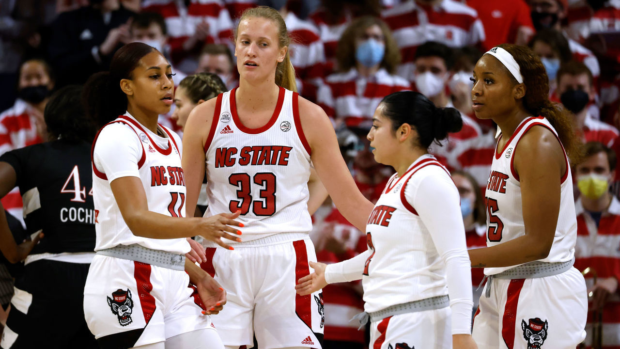 RALEIGH, NC - JANUARY 20: Jakia Brown-Turner #11 high-fives Raina Perez #2 of the NC State Wolfpack during their game against the Louisville Cardinals at Reynolds Coliseum on January 20, 2022 in Raleigh, North Carolina. NC State won 68-59.