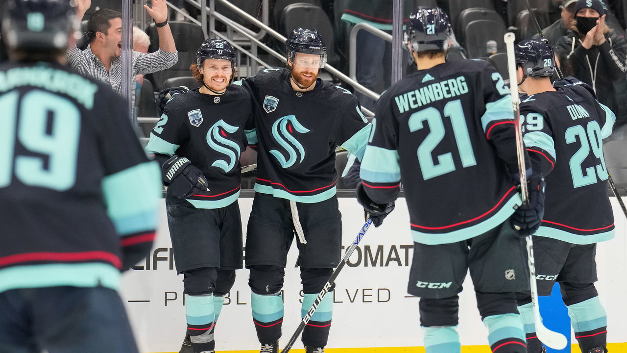 SEATTLE, WASHINGTON - JANUARY 23: Mason Appleton #22 of the Seattle Kraken (L) celebrates with teammates after scoring a goal against the Florida Panthers to take a 4-3 lead during the third period at Climate Pledge Arena on January 23, 2022 in Seattle, Washington.