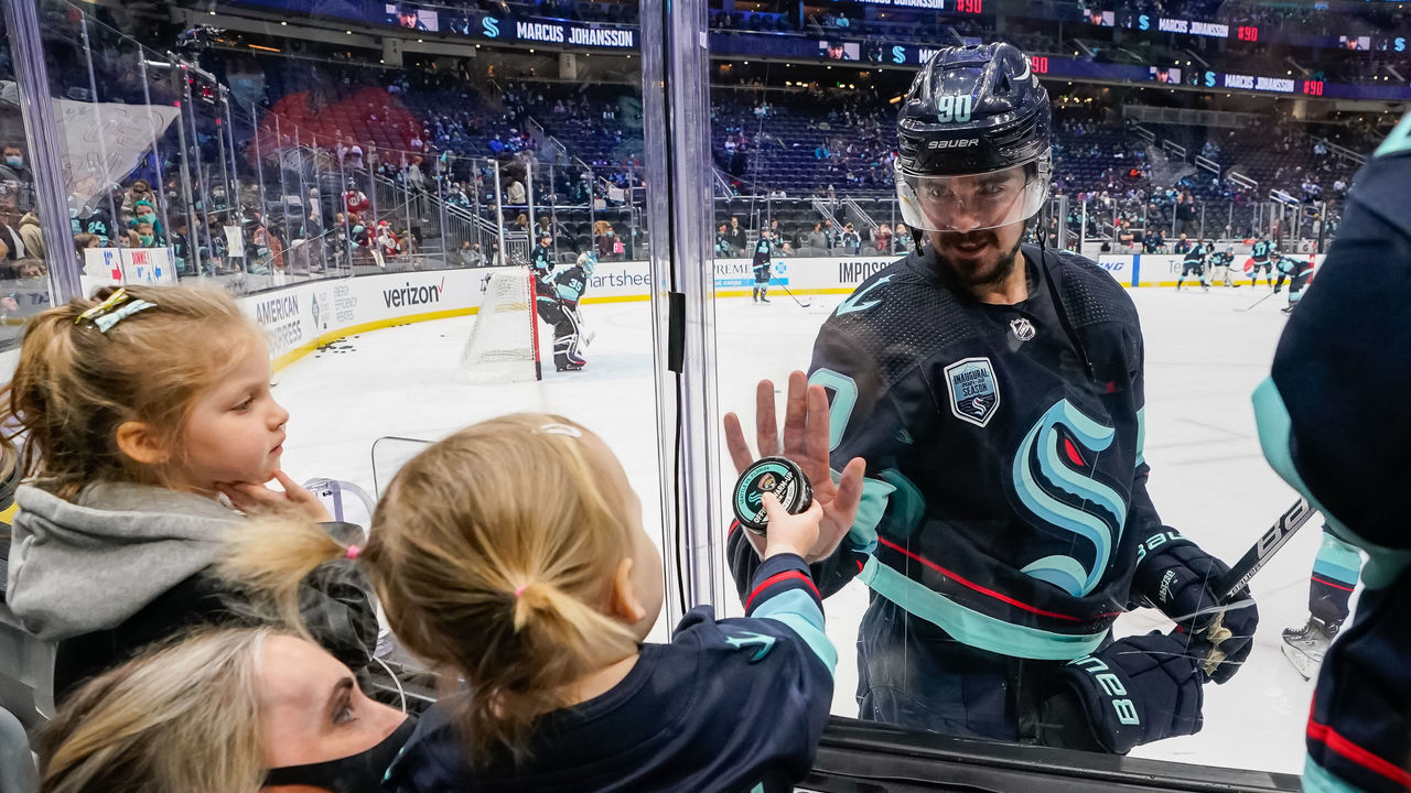 SEATTLE, WASHINGTON - JANUARY 23: Marcus Johansson #90 of the Seattle Kraken interacts with a fan before the game against the Florida Panthers at Climate Pledge Arena on January 23, 2022 in Seattle, Washington.