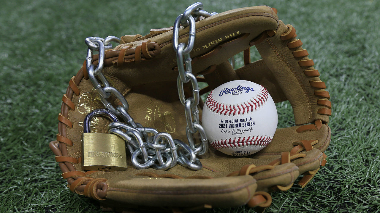 Atlanta, GA - January 09: An Official Rawlings Major League baseball sits with a glove, lock and chain to represent the lockout between Major League Baseball (MLB) and the Major League Baseball Players Association (MLBPA) on January 09, 2022 in Atlanta, Georgia.