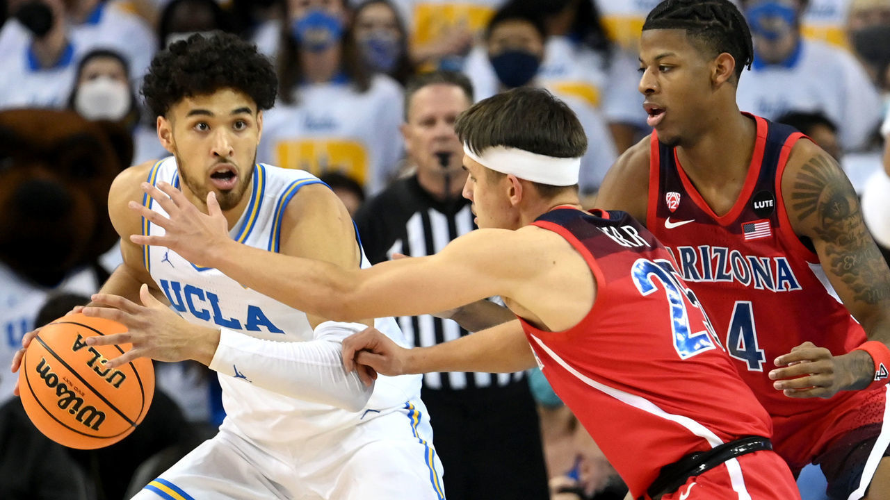 LOS ANGELES, CA - JANUARY 25: Kerr Kriisa #25 of the Arizona Wildcats guards Johnny Juzang #3 of the UCLA Bruins in the first half the game at UCLA Pauley Pavilion on January 25, 2022 in Los Angeles, California.