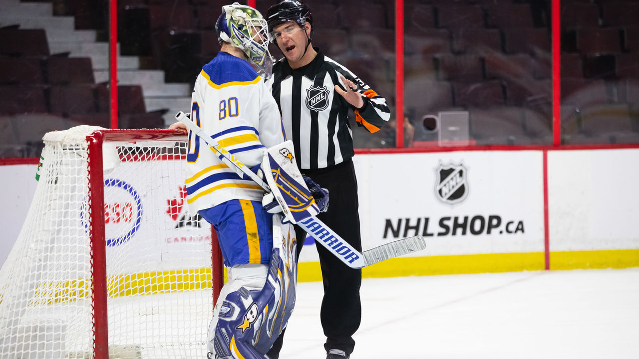 OTTAWA, ON - JANUARY 25: Referee Pierre Lambert (37) talks to Buffalo Sabres Goalie Aaron Dell (80) after a whistle during second period National Hockey League action between the Buffalo Sabres and Ottawa Senators on January 25, 2022, at Canadian Tire Centre in Ottawa, ON, Canada.