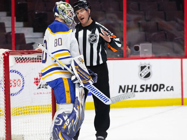 OTTAWA, ON - JANUARY 25: Referee Pierre Lambert (37) talks to Buffalo Sabres Goalie Aaron Dell (80) after a whistle during second period National Hockey League action between the Buffalo Sabres and Ottawa Senators on January 25, 2022, at Canadian Tire Centre in Ottawa, ON, Canada.