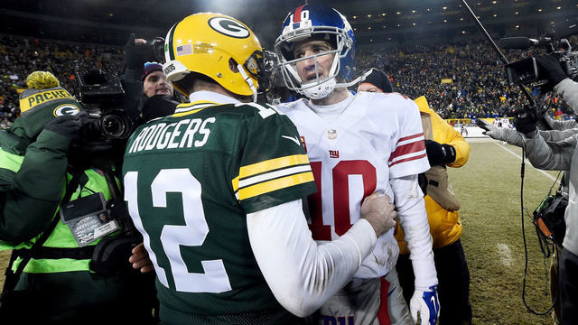GREEN BAY, WI - JANUARY 8: Aaron Rodgers #12 of the Green Bay Packers and Eli Manning #10 of the New York Giants meet after the Green Bay Packers beat the New York Giants 38-31 in the NFC Wild Card game at Lambeau Field on January 8, 2017 in Green Bay, Wisconsin.