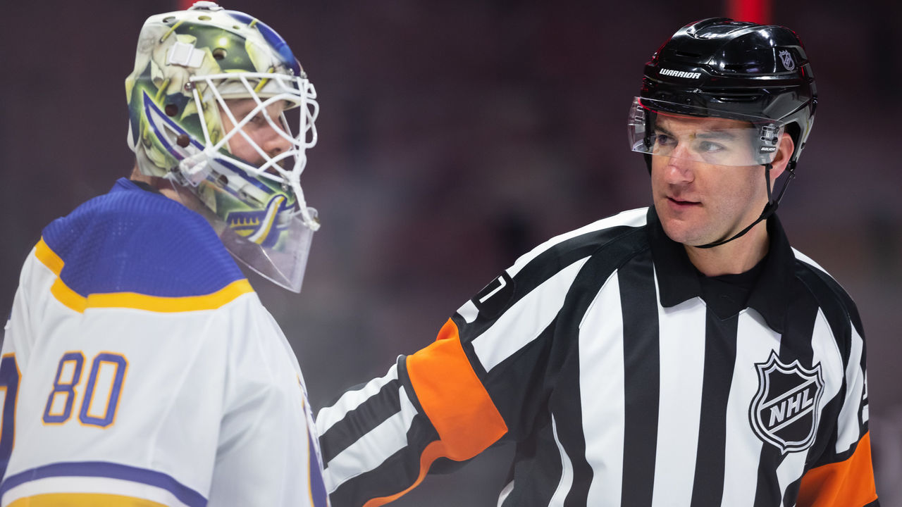 OTTAWA, ON - JANUARY 25: Referee Pierre Lambert (37) talks to Buffalo Sabres Goalie Aaron Dell (80) after a whistle during second period National Hockey League action between the Buffalo Sabres and Ottawa Senators on January 25, 2022, at Canadian Tire Centre in Ottawa, ON, Canada.