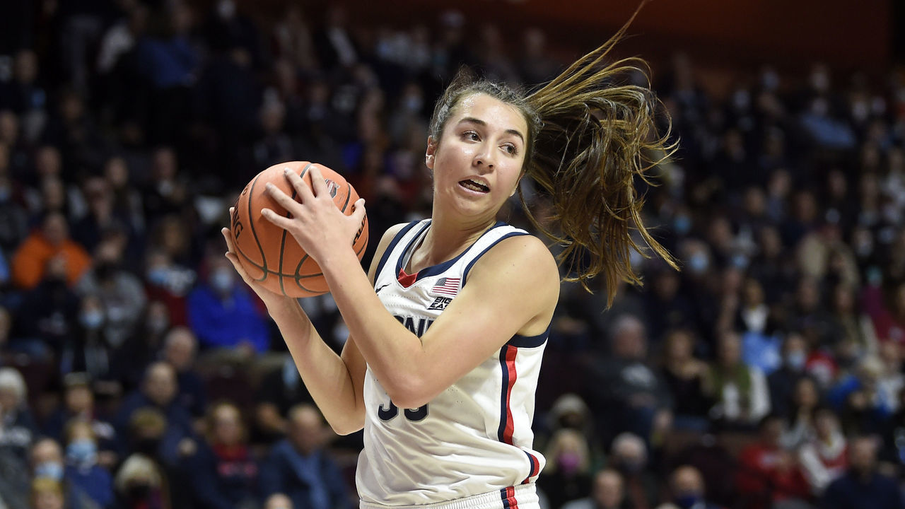 UNCASVILLE, CONNECTICUT - DECEMBER 19: Caroline Ducharme #33 of the Connecticut Huskies grabs a rebound against the Louisville Cardinals in the Basketball Hall of Fame Women's Showcase at Mohegan Sun Arena on December 19, 2021 in Uncasville, Connecticut.