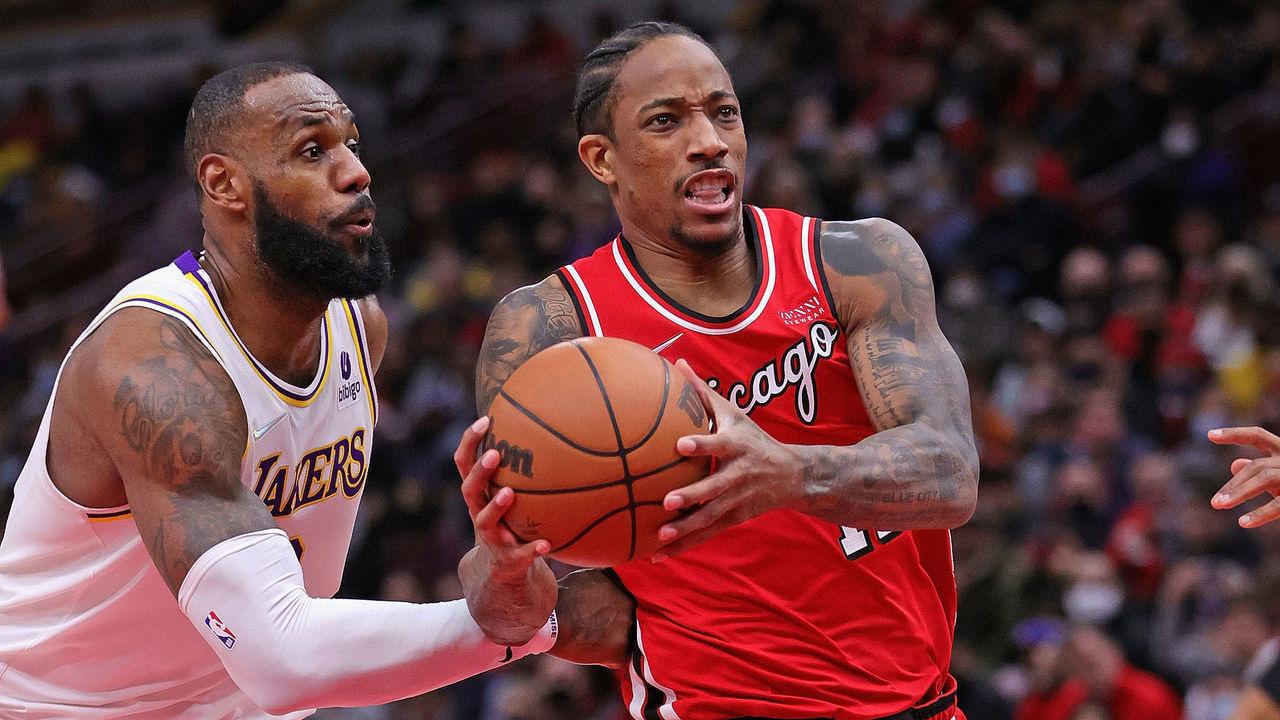 CHICAGO, ILLINOIS - DECEMBER 19: DeMar DeRozan #11 of the Chicago Bulls drives past LeBron James #6 of the Los Angeles Lakers at the United Center on December 19, 2021 in Chicago, Illinois. The Bulls defeated the Lakers 115-110.