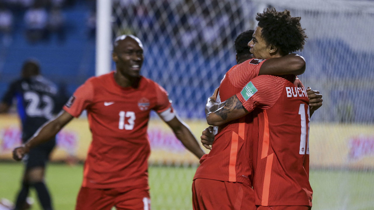 Canadian football players celebrate after scoring against Honduras during their FIFA World Cup Qatar 2022 Concacaf qualifier match at the Olimpico Metropolitano Stadium in San Pedro Sula, Honduras on January 27, 2022.