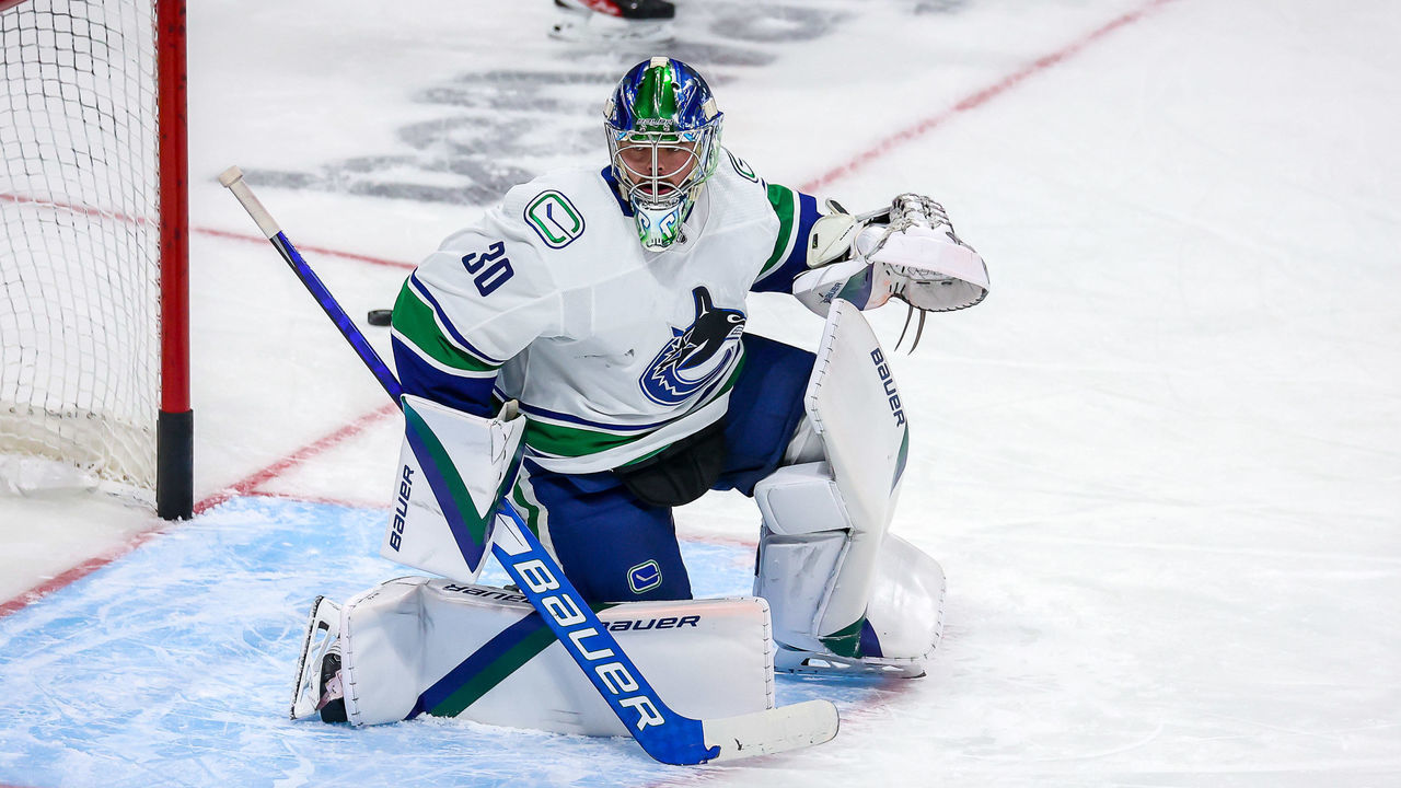 WINNIPEG, MB - JANUARY 27: Goaltender Spencer Martin #30 of the Vancouver Canucks takes part in the pre-game warm up prior to NHL action against the Winnipeg Jets at the Canada Life Centre on January 27, 2022 in Winnipeg, Manitoba, Canada.