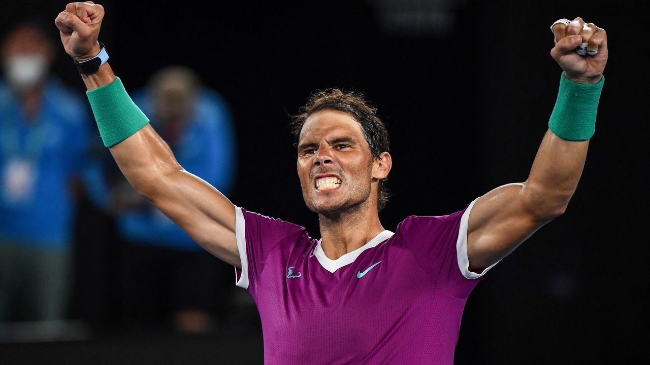 TOPSHOT - Spain's Rafael Nadal celebrates after victory against Italy's Matteo Berrettini during their men's singles semi-final match on day twelve of the Australian Open tennis tournament in Melbourne on January 28, 2022. - -- IMAGE RESTRICTED TO EDITORIAL USE - STRICTLY NO COMMERCIAL USE --