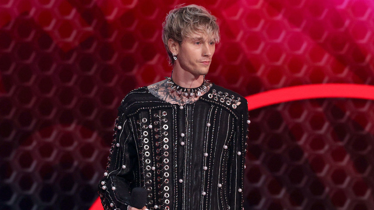 LOS ANGELES, CALIFORNIA - NOVEMBER 21: Machine Gun Kelly speaks onstage during the 2021 American Music Awards at Microsoft Theater on November 21, 2021 in Los Angeles, California.