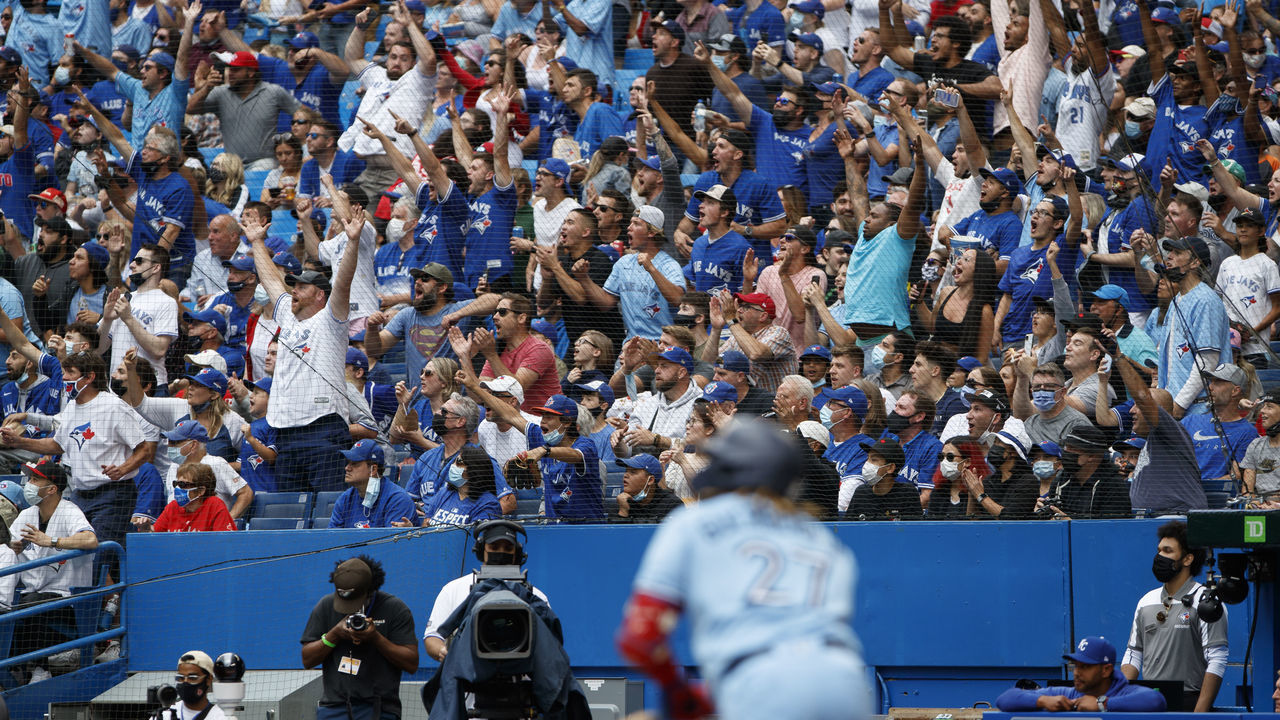 TORONTO, ON - JULY 31: Fans watch as Vladimir Guerrero Jr. #27 of the Toronto Blue Jays hits a deep fly out against the Kansas City Royals during the eight inning of their MLB game at Rogers Centre on July 31, 2021 in Toronto, Ontario.
