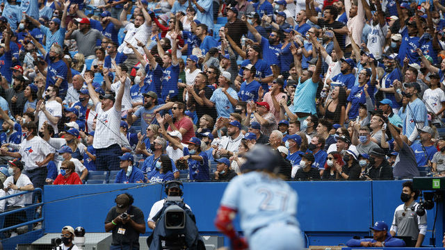 TORONTO, ON - JULY 31: Fans watch as Vladimir Guerrero Jr. #27 of the Toronto Blue Jays hits a deep fly out against the Kansas City Royals during the eight inning of their MLB game at Rogers Centre on July 31, 2021 in Toronto, Ontario.