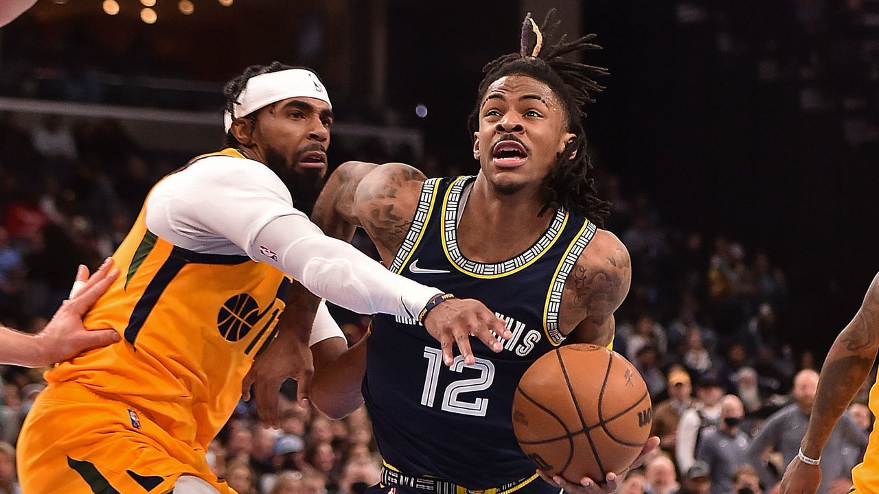 MEMPHIS, TENNESSEE - JANUARY 28: Ja Morant #12 of the Memphis Grizzlies drives to the basket against Mike Conley #11 of the Utah Jazz during the first half at FedExForum on January 28, 2022 in Memphis, Tennessee.