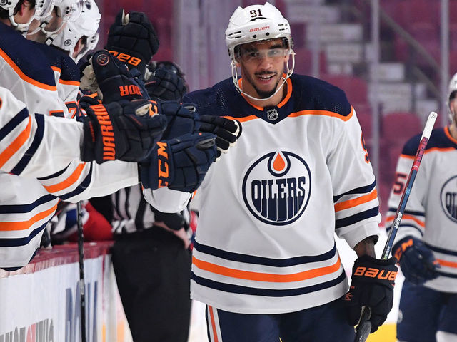MONTREAL, QC - JANUARY 29: Evander Kane #91 of the Edmonton Oilers celebrates with the bench after scoring a goal against the Montreal Canadiens in the NHL game at the Bell Centre on January 29, 2021 in Montreal, Quebec, Canada.