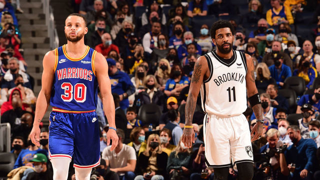 SAN FRANCISCO, CA - JANUARY 29: Stephen Curry #30 of the Golden State Warriors and Kyrie Irving #11 of the Brooklyn Nets look on during the game on January 29, 2022 at Chase Center in San Francisco, California. NOTE TO USER: User expressly acknowledges and agrees that, by downloading and or using this photograph, user is consenting to the terms and conditions of Getty Images License Agreement. Mandatory Copyright Notice: Copyright 2022 NBAE