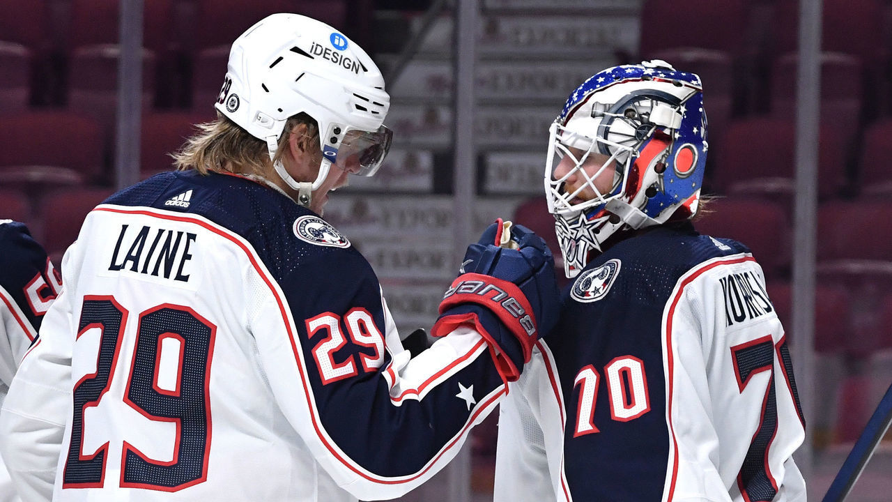 MONTREAL, QC - JANUARY 30: Joonas Korpisalo #70 and Patrik Laine #29 of the Colombus Blue Jackets celebrate after defeating the Montreal Canadiens in the NHL game at the Bell Centre on January 30, 2022 in Montreal, Quebec, Canada.